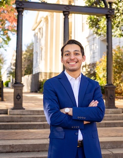 Shot of Mathew Bazan in front of beautiful building